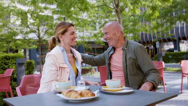 Reunion of two friends outdoors in cafeteria, life after covid-19 vaccination and back to normal concept.