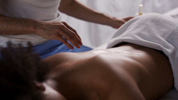 Young woman having relaxing back massage at the spa.