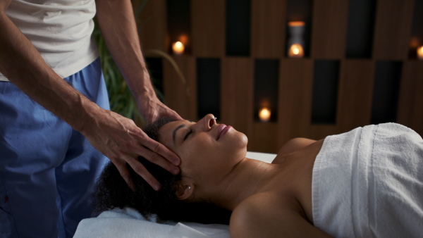 Young woman having relaxing head massage at the spa.