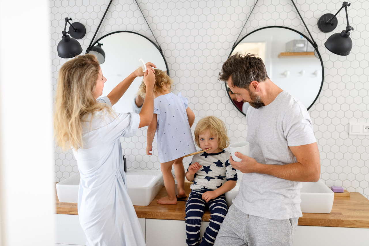 Parents and kids, having morning bathroom routine. brushing teeth and washing face, enjoying together time at home.