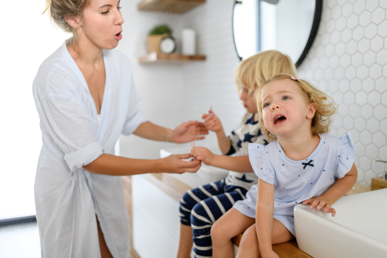 Parents and kids, having morning bathroom routine. brushing teeth and washing face, enjoying together time at home.