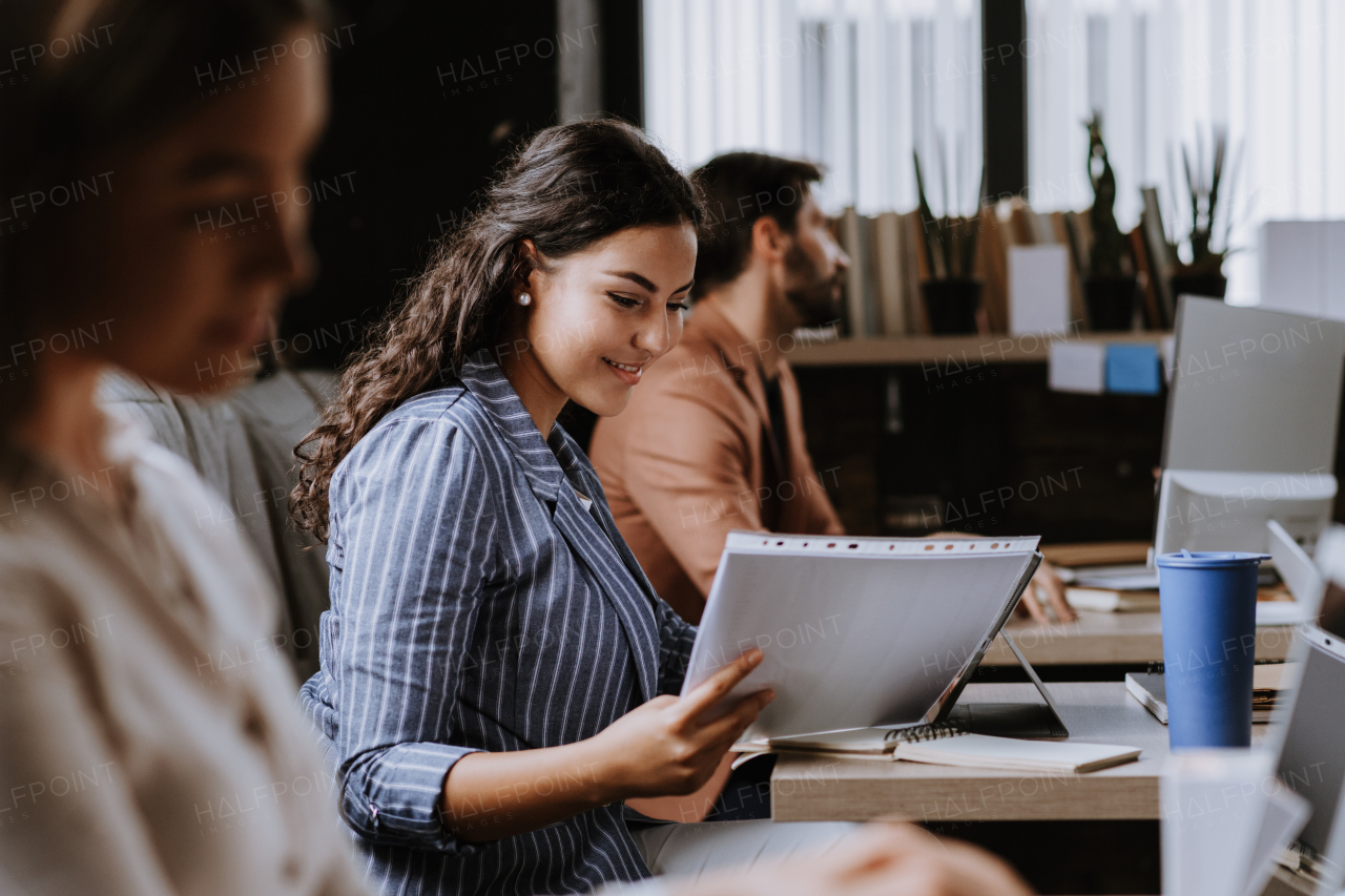 Group of freelancers and remote businesspeople working in shared work area. Concept of coworking, common workspaces for business, startups. Working remotely from coffee shop.