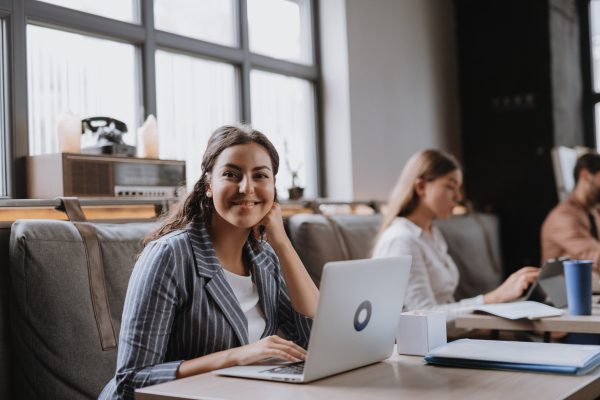 Group of freelancers and remote businesspeople working in shared work area. Concept of coworking, common workspaces for business, startups. Working remotely from coffee shop.