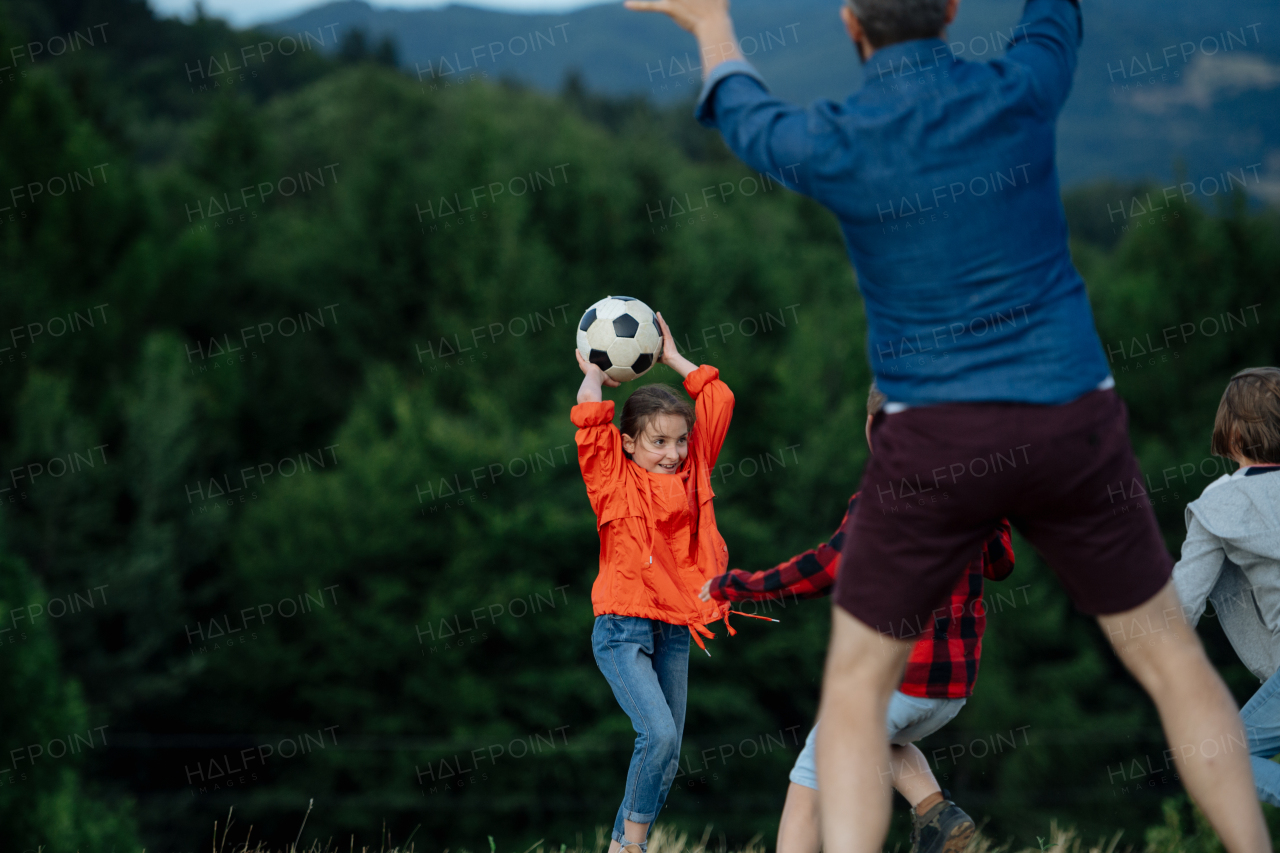 Young students playing with teacher outdoors, in nature, during field teaching class, running with ball, Dedicated teachers during outdoor active education.Teachers' Day.