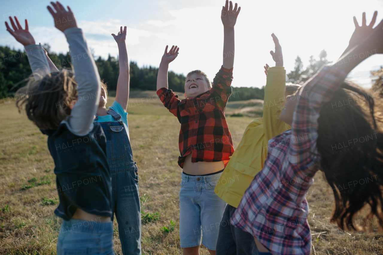 Portrait of young classmates, students during biology field teaching class, successful experiment, hands in air. Learning about ecosystem, ecology and nature.