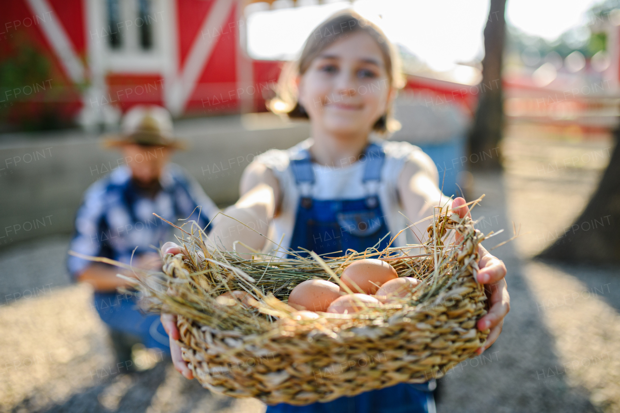 Beautiful young girl helping on family farm during summer, holding lavender plant in pot. . Future female farmer.