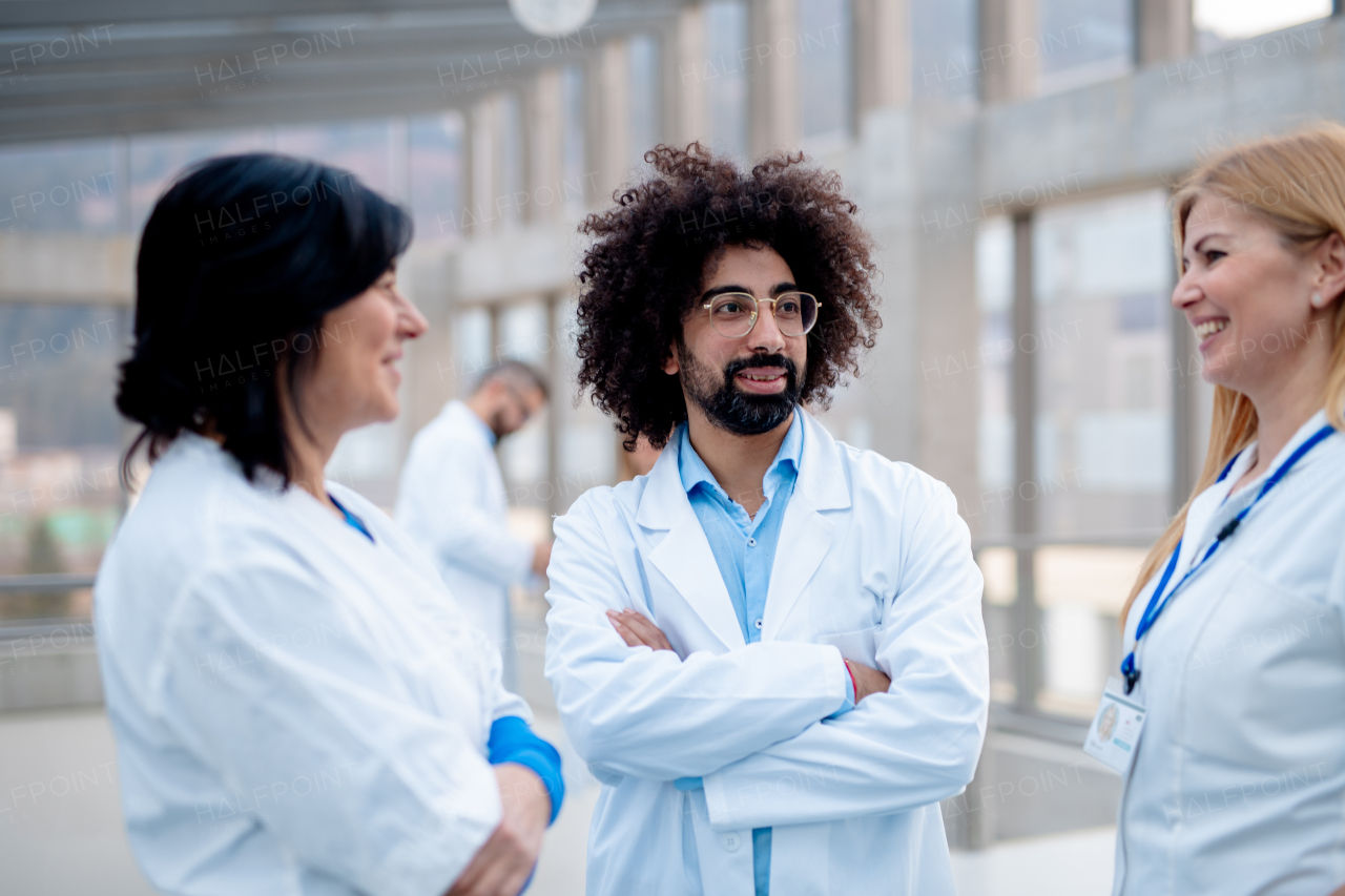 Group of doctors talking during conference, discussing research findings. Medical networking. Medical experts attending an education event, seminar in board room. Age and gender equity in healthcare.