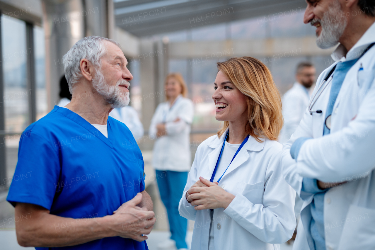 Group of doctors talking during conference, discussing research findings. Medical networking. Medical experts attending an education event, seminar in board room. Age and gender equity in healthcare.