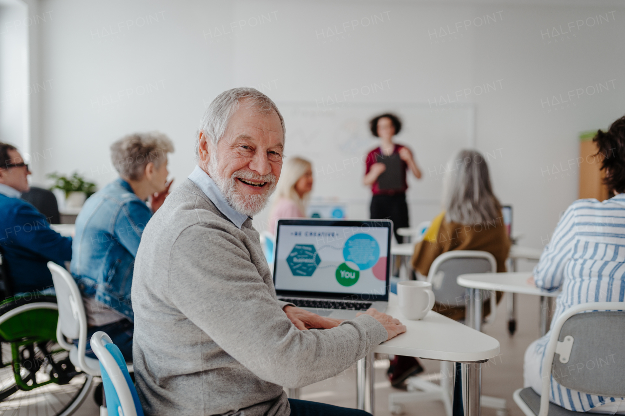 Teacher explaining senior students how to start their own business. Elderly people attending computer and technology education class. Entrepreneurship program for seniors