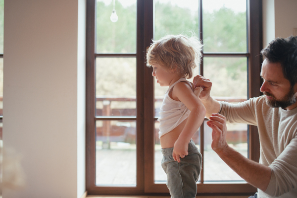 Father is checking his son's skin, looking for rashes or skin reactions