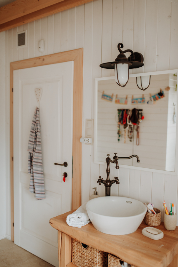 Modern attic bathroom with a wooden sink table