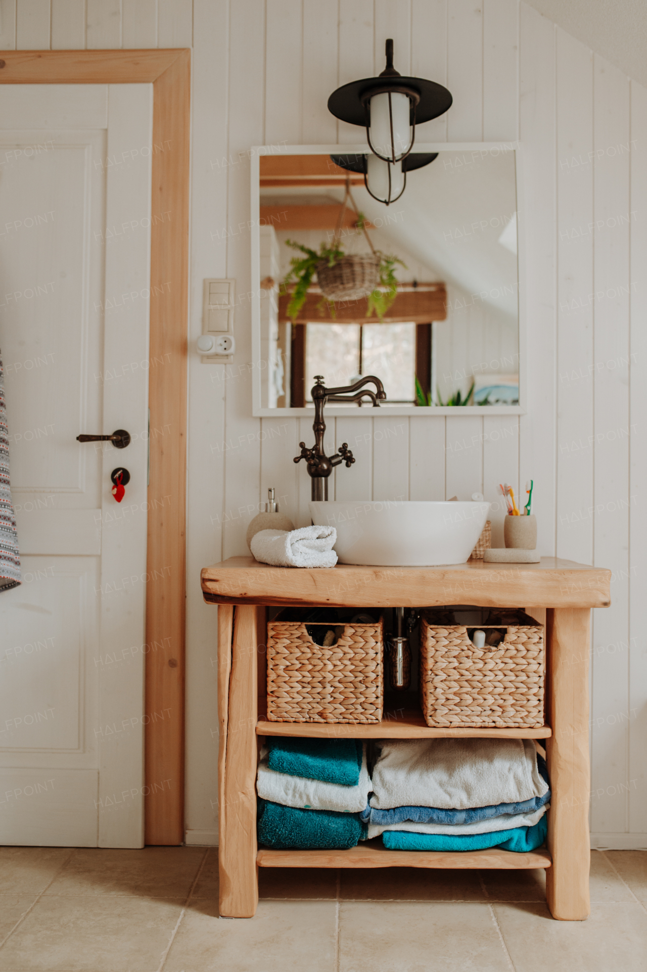 Modern attic bathroom with a wooden sink table