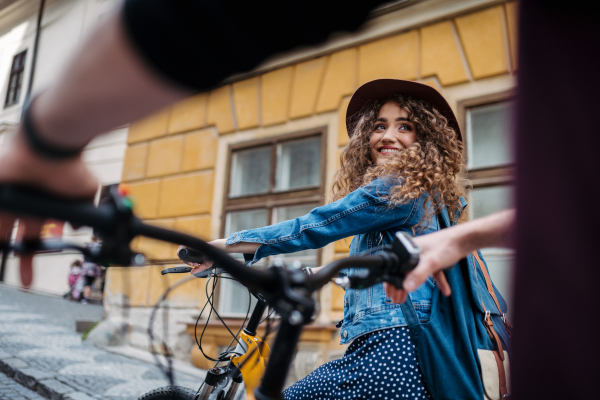 Couple travellers on electric scooters in city, sightseeing. Young tourist using bikes during their summer trip, vacation.