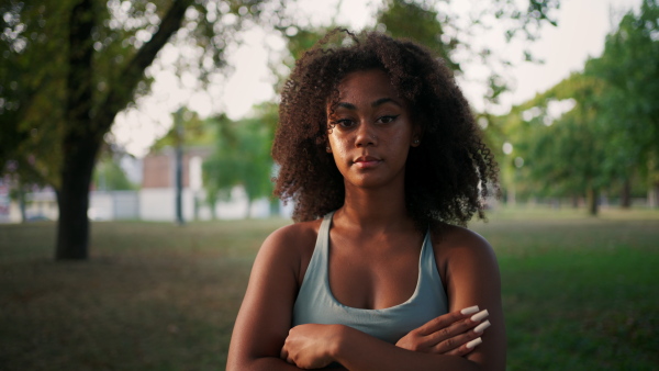 Video of a young sporty woman exercising in city park. Doing yoga outdoors at morning.