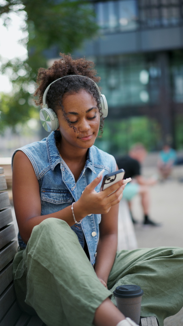 A video of gorgeous young woman in the city, headphones on head.