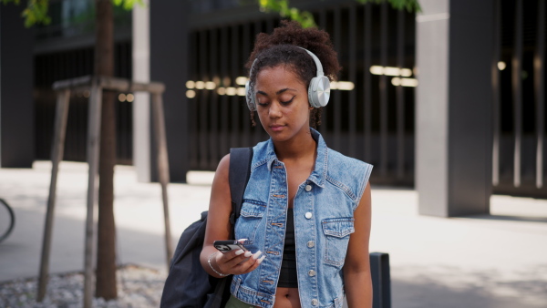 A video of gorgeous young woman in the city, headphones on head.