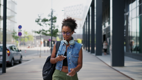 A video of gorgeous young woman in the city, headphones on head.