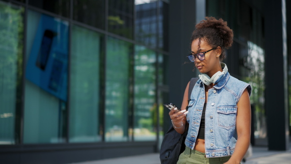 A video of gorgeous young woman in the city, headphones on head.