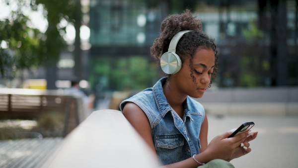 A video of gorgeous young woman in the city, headphones on head.