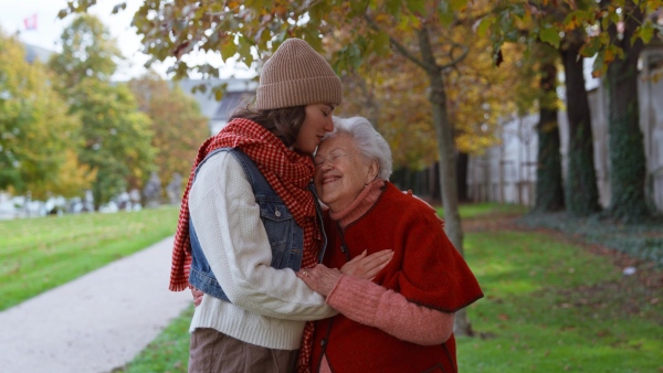 A video of granddaughter on an autumn walk in the park with her grandmother.