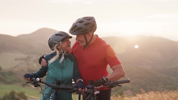 A video of beautiful senior couple on bike ride in autumn nature.