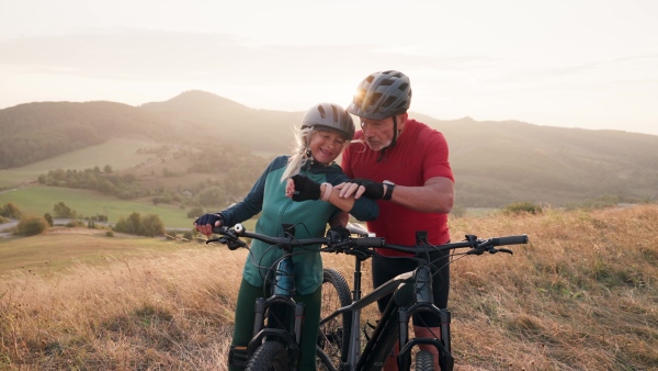 A video of beautiful senior couple on bike ride in autumn nature.