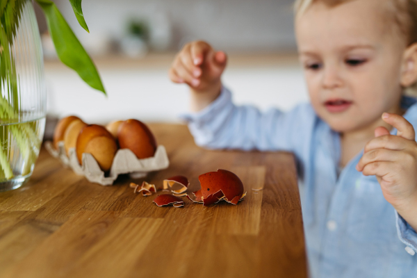 Little boy and easter eggs dyed with onion skins.