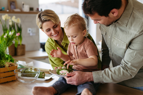 Family eating green dishes as a tradition on Easter Green Thursday.