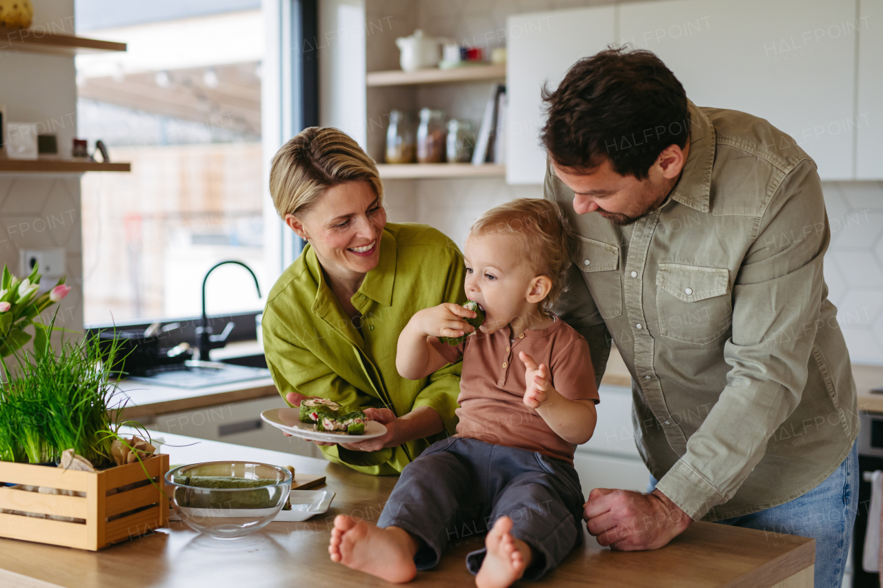 Family eating green dishes as a tradition on Easter Green Thursday.