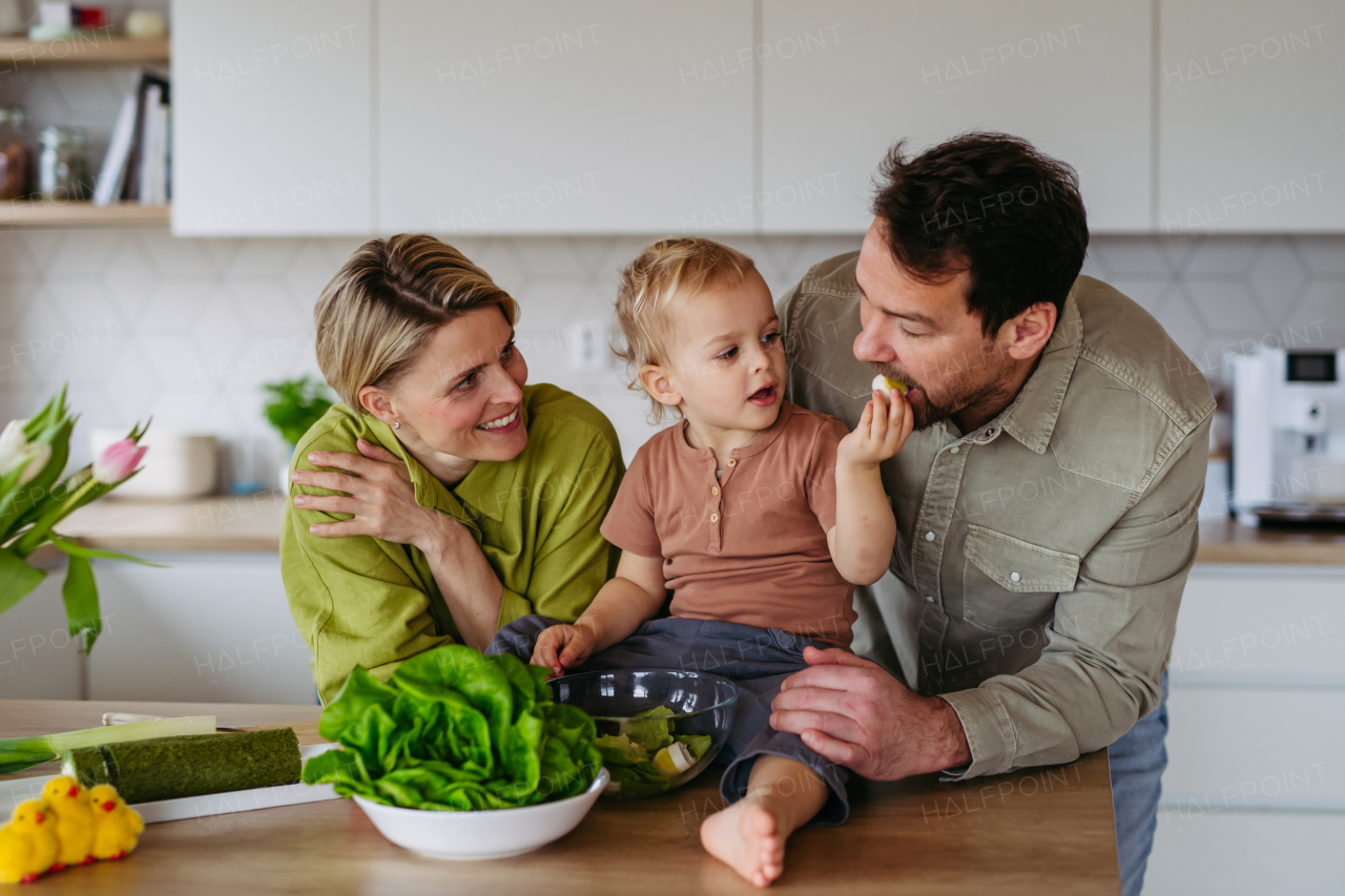 Family preparing lettuce salad to celebrate Easter Green Thursday. Green dish during Maundy thursday.