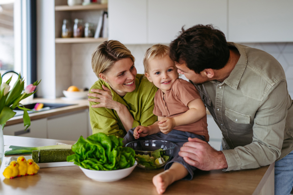 Family preparing lettuce salad to celebrate Easter Green Thursday. Green dish during Maundy thursday.