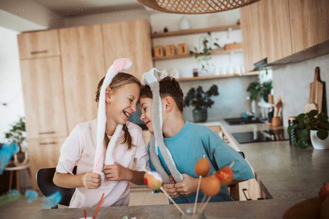 Girl and boy paiting eggs for easter. Siblings decorate egshells for easter egg decorating.