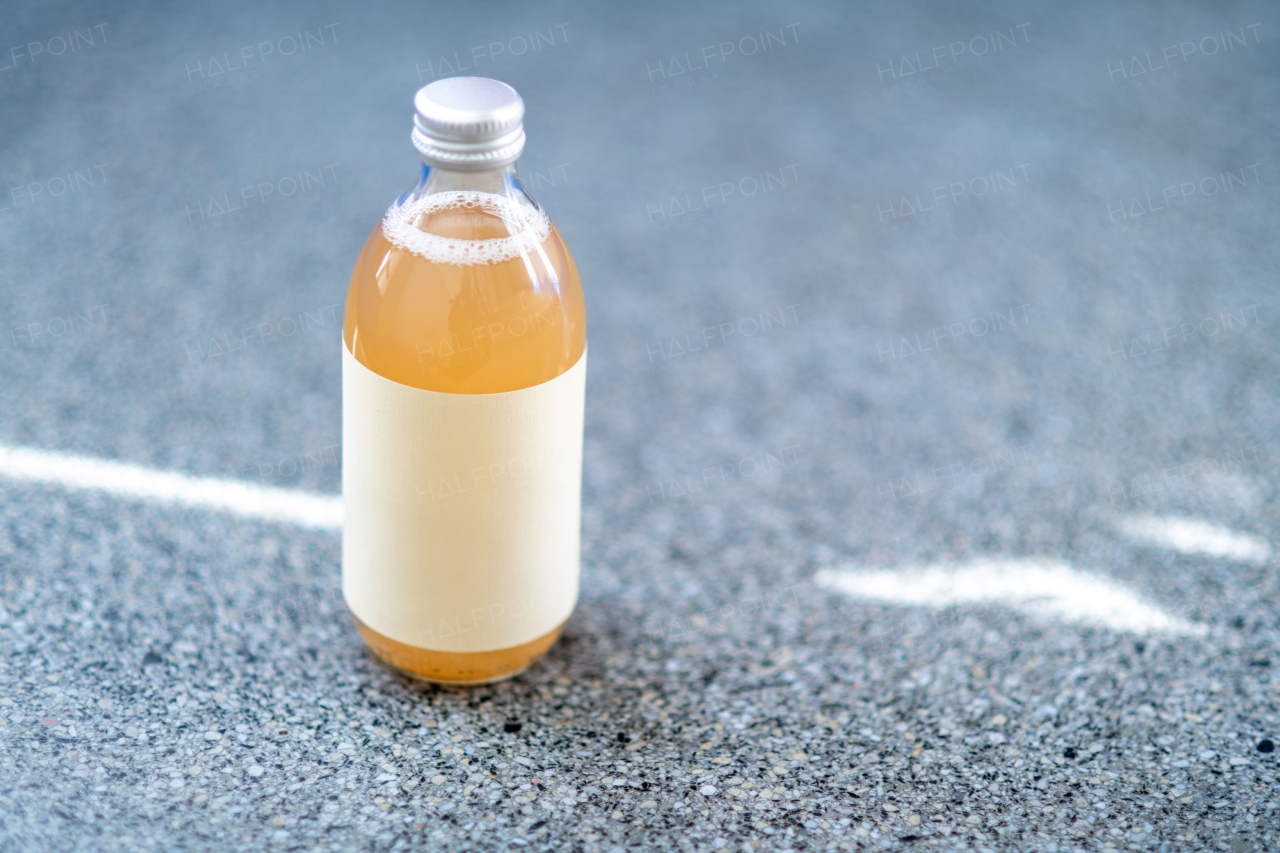 Glass bottle with kombucha. Handmade apple juice in a bottle.