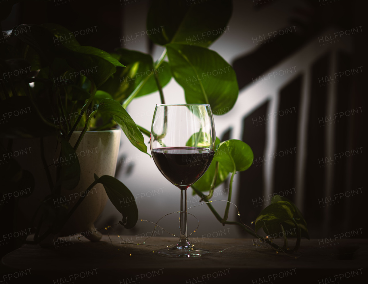 Glass of rich red wine with a warm, elegant ambiance.