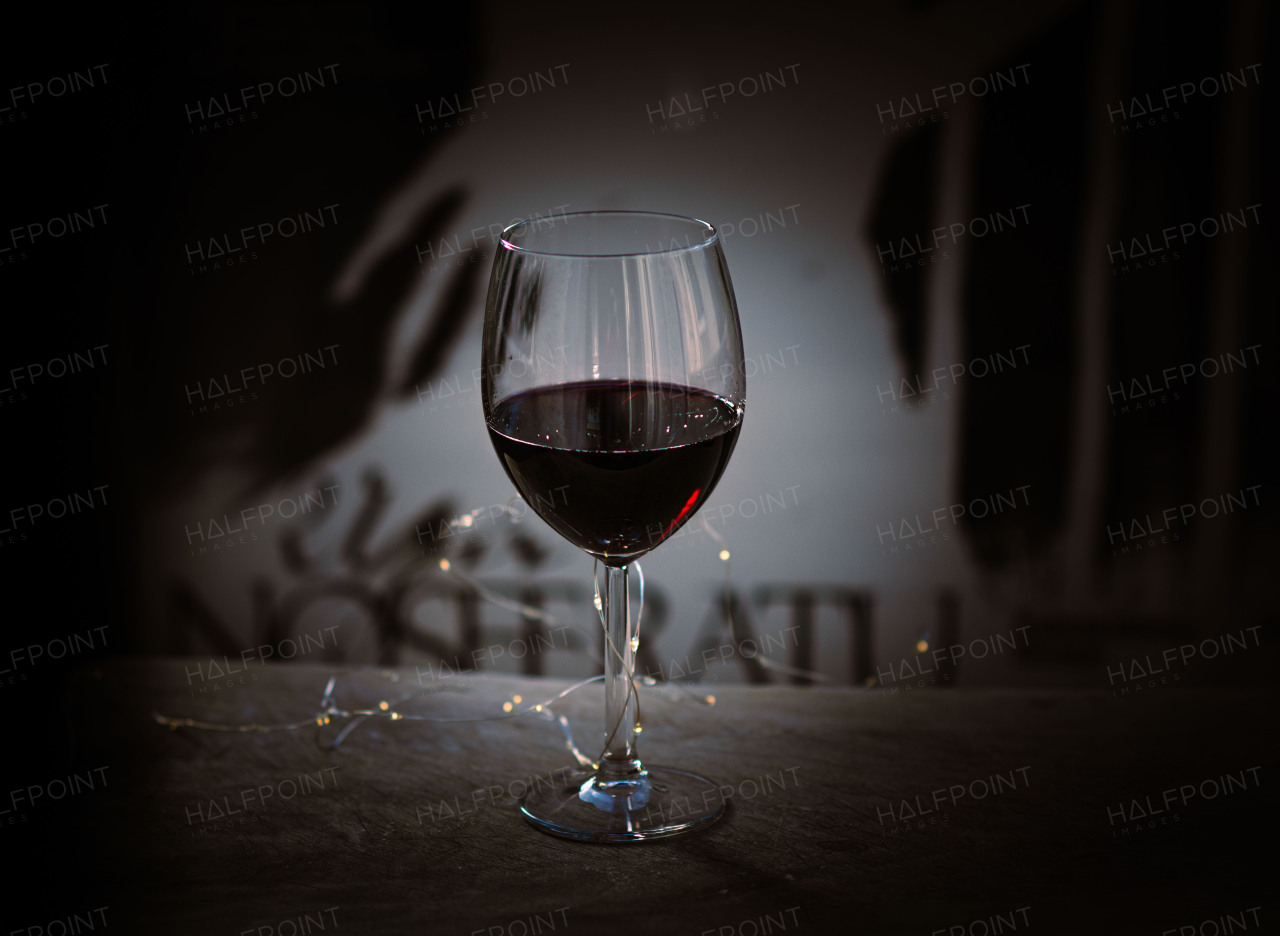 Glass of rich red wine with a warm, elegant ambiance.