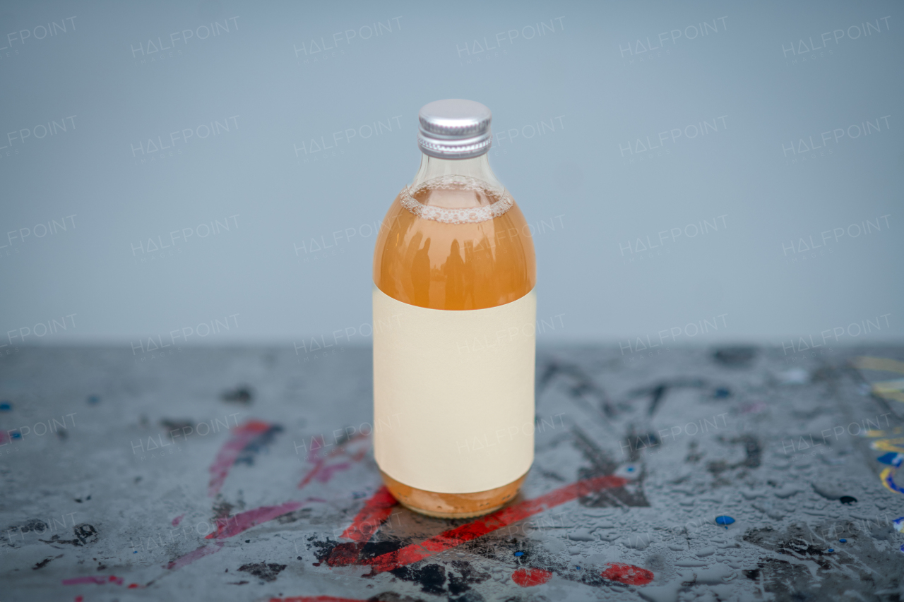 Glass bottle with kombucha. Handmade apple juice in a bottle.