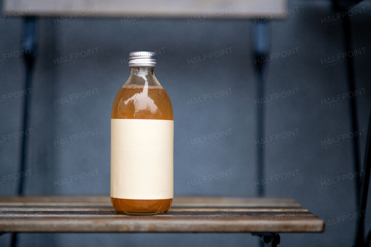 Glass bottle with kombucha. Handmade apple juice in a bottle.