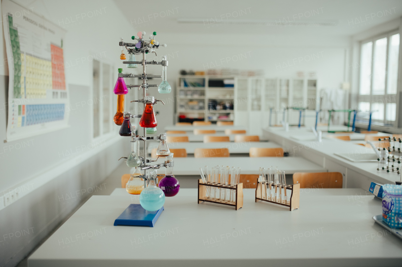 Science lab or specialized classroom for chemistry, biology or physic in school. Test tube kit and laboratory glassware on table.