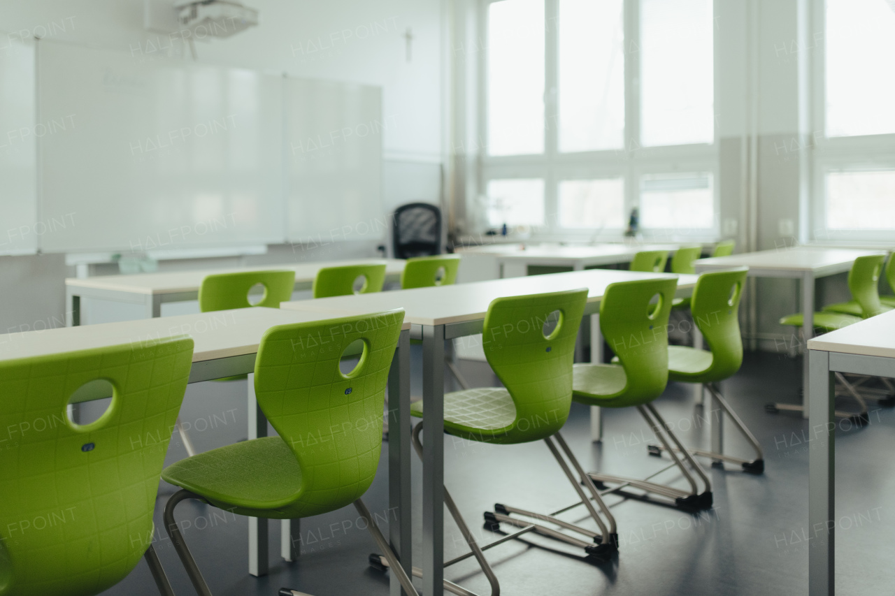 Biology science lab or classroom in school. Empty classroom with green plastic chairs.