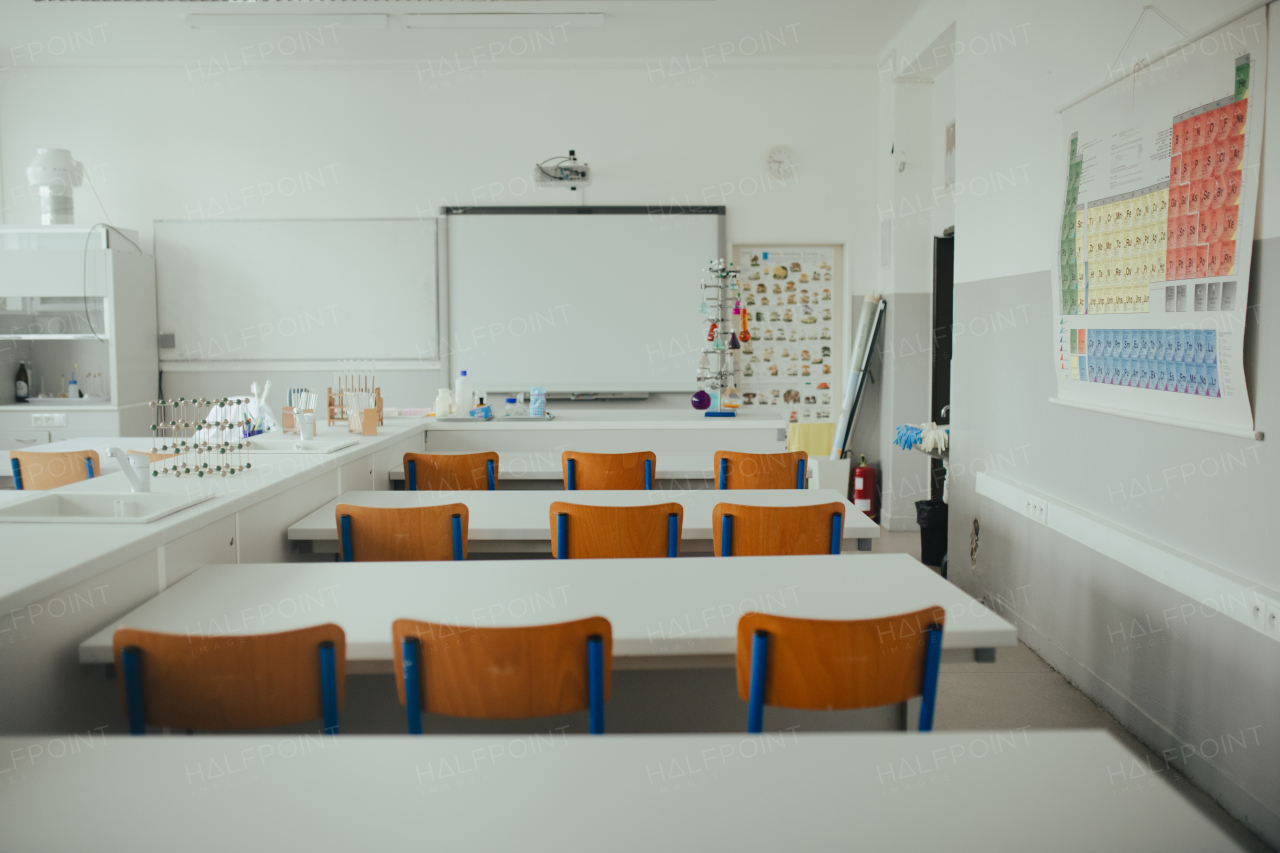 Science lab or specialized classroom for chemistry, biology or physic in school. Test tube kit and laboratory glassware on table.