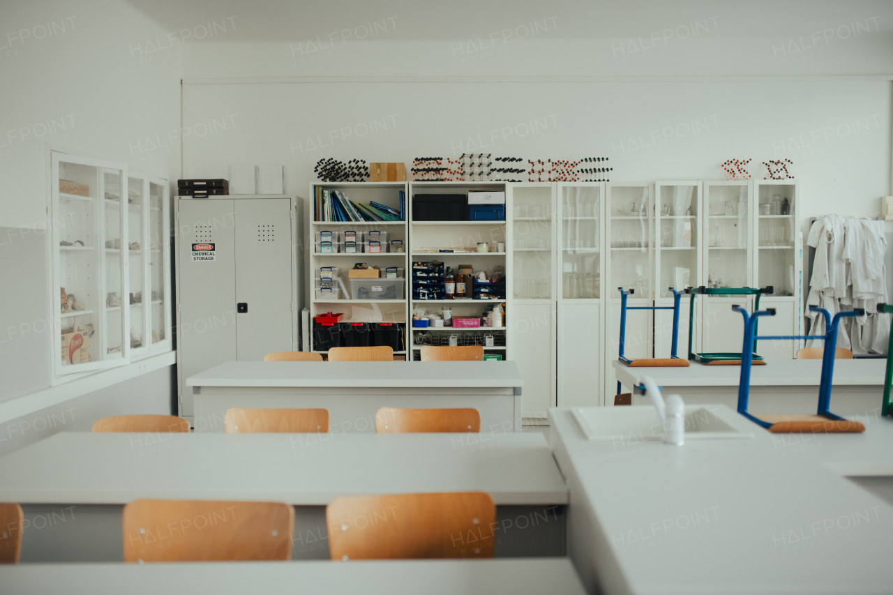 Science lab or specialized classroom for chemistry, biology or physic in school. Test tube kit and laboratory glassware on table.