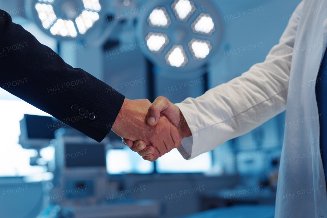 Hospital business handshake in medical environment. Strategic collaboration in medical industry.