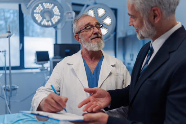 Doctor signing contract with pharmaceutical representative, successful deal.