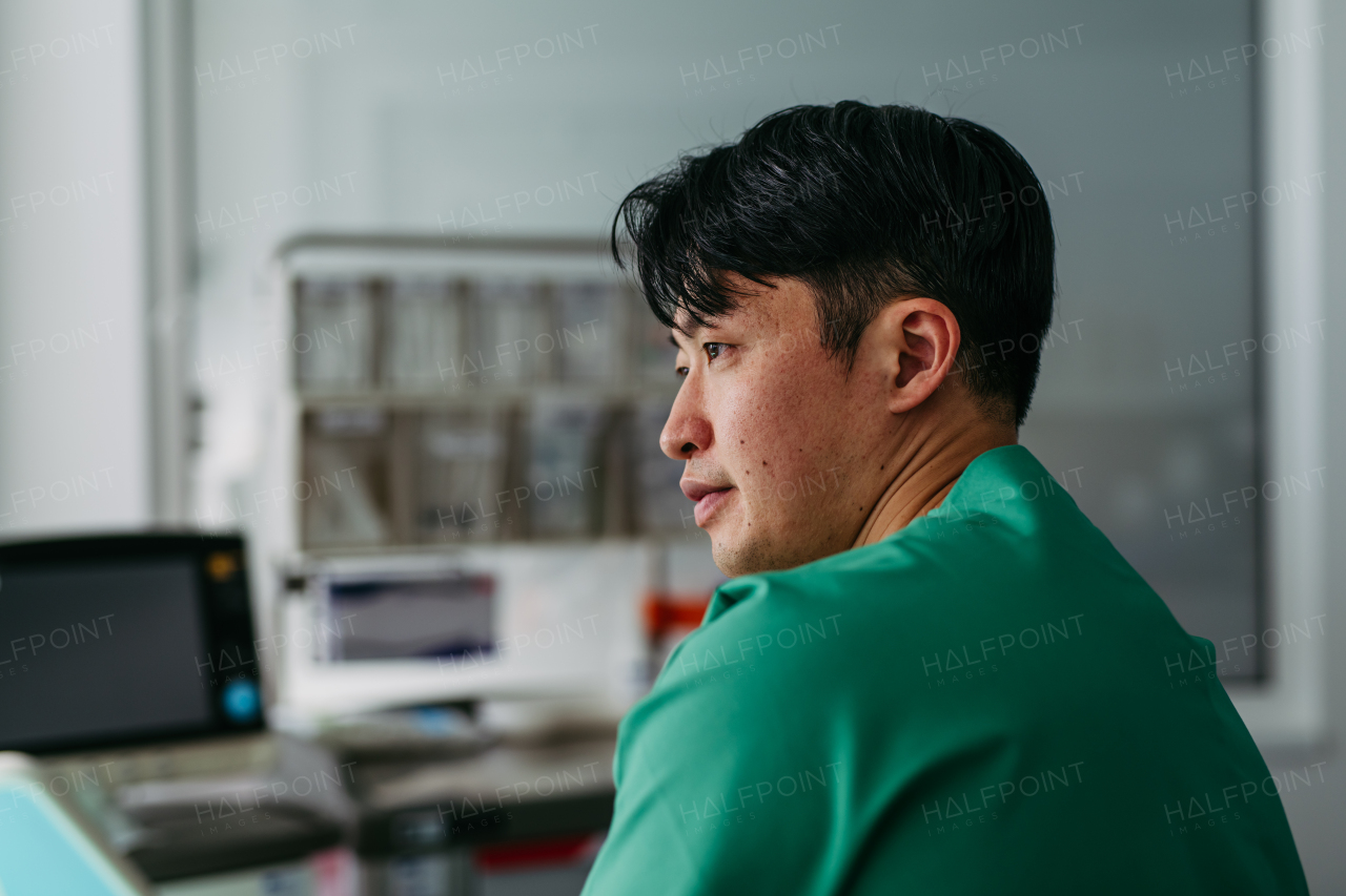 Handsome Asian doctor in a hospital setting.
