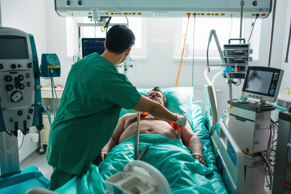 Doctor performing CPR and electric shock during cardiac arrest.
