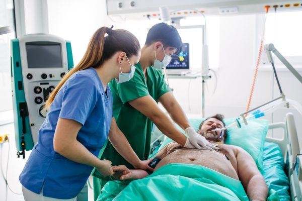 Hospital team saving intubated patient with cardiac arrest using CPR.