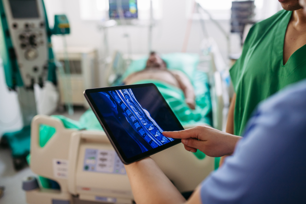 Doctors consulting, reviewing test results of critical patient in icu.