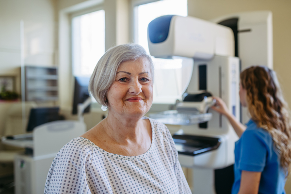 Senior female patient receiving breast cancer screening as part of routine exam
