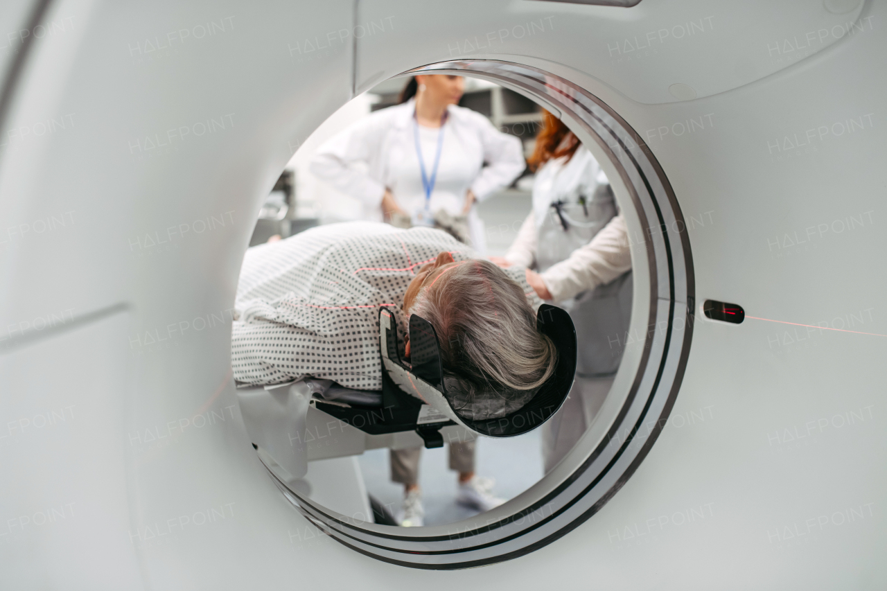 CT scanner view of senior patient during medical imaging procedure. Older woman undergoing MRI scan.