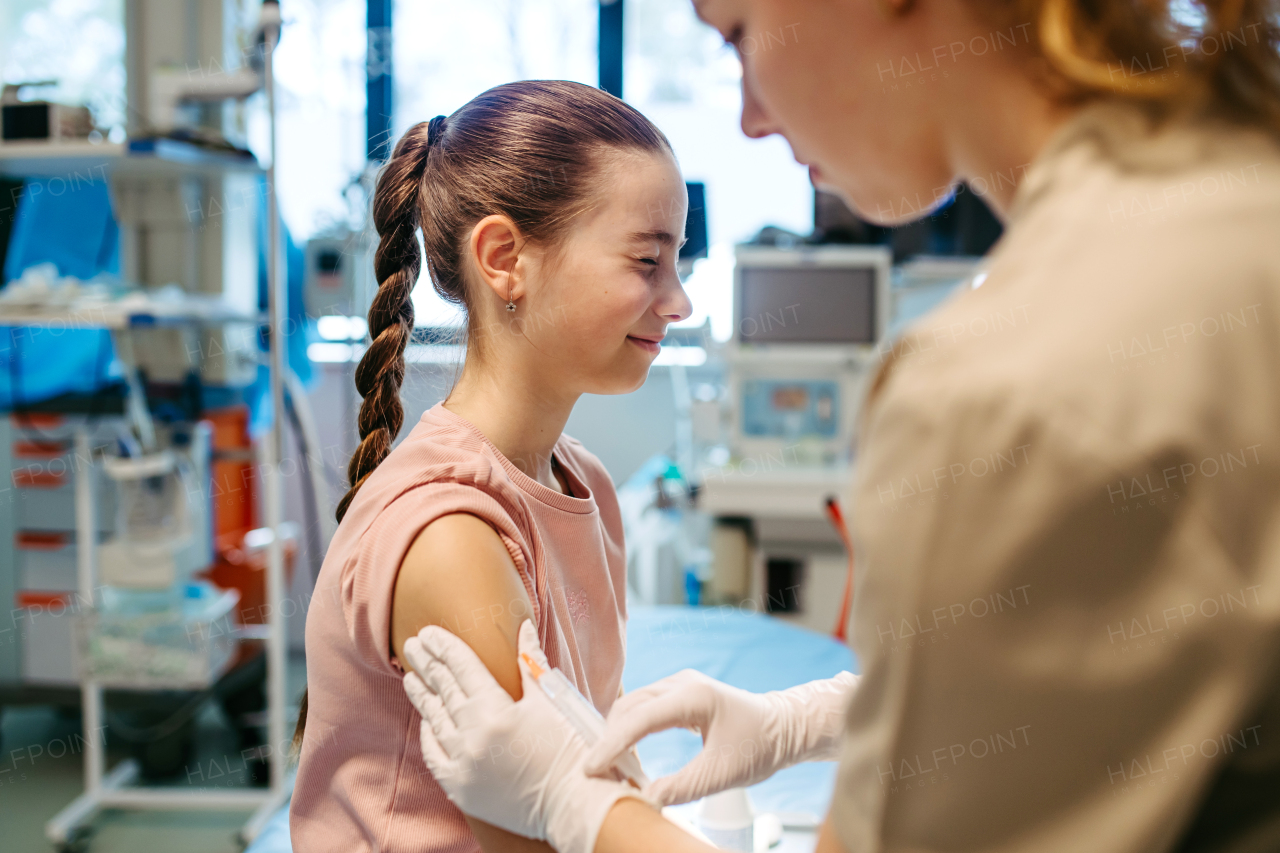 Close-up of vaccine injection for young girl in doctor's office